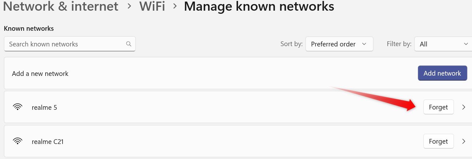 Forgetting an old network in the Windows Settings app.