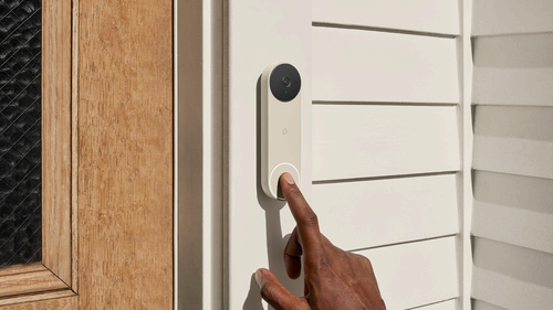 Pressing the button on a Google Nest smart doorbell.