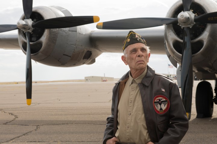 A veteran standing in front of a plane on Better Call Saul.