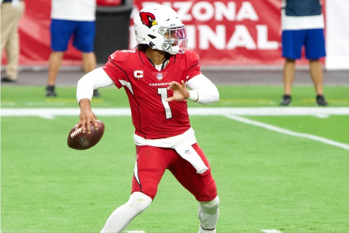 Kyler Murray prepares to throw a football.