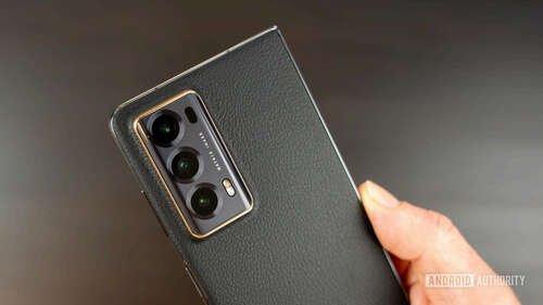 Honor Magic V2 camera closeup in hand showing leather back