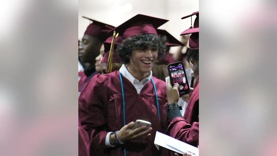 Gavin Guffey in a graduation cap and gown