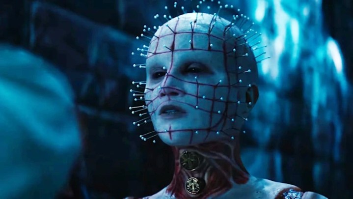 A female Pinhead looks on in Hellraiser.