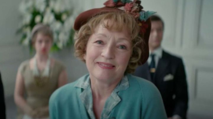 Lesley Manville as Mrs. Harris smiling warmly in the film Mrs. Harris Goes to Paris.