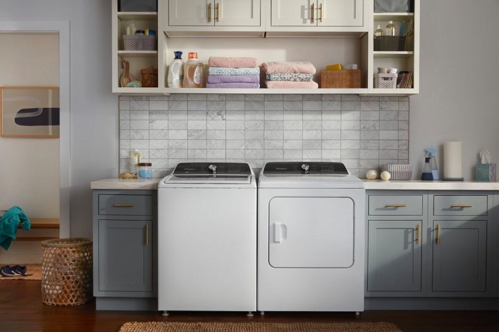 A Whirlpool washer and dryer set installed in a kitchen.