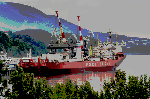 A red cargo ship is shown in a harbor surrounded by mountainous terrain.