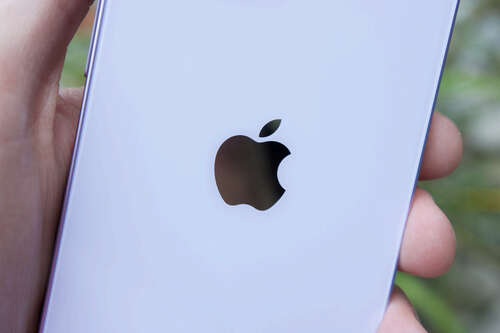 The Apple logo on the back of an iPhone 14.