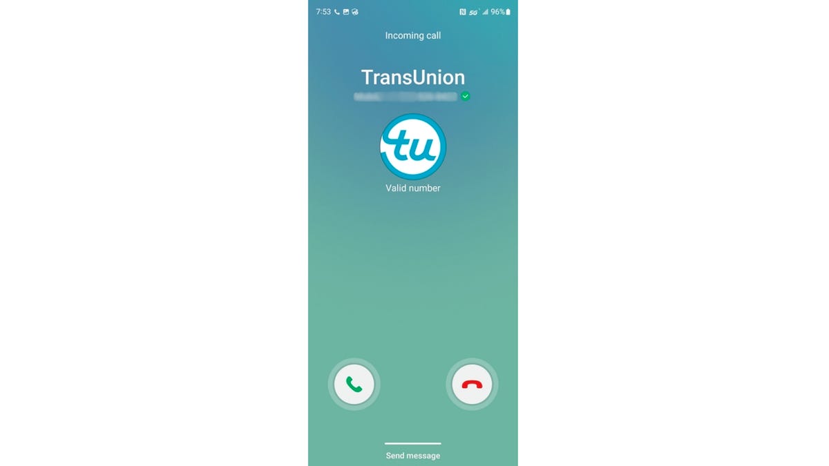 A smartphone screen with a logo for a company appearing on a call screen -- in this case, TransUnion's circular white logo with the letters 'tu' in blue.