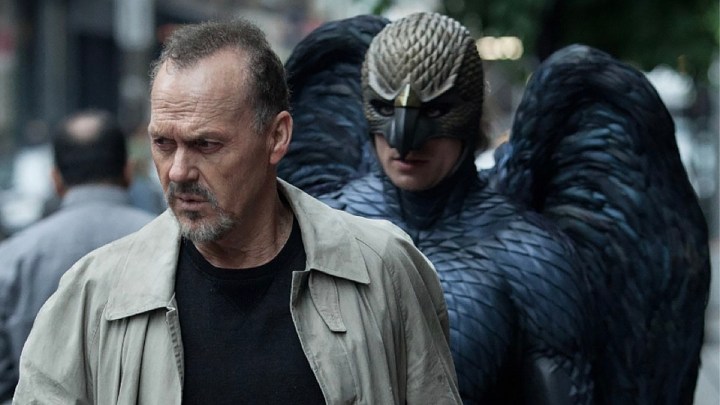 Michael Keaton being followed by a man in a bird costume in a scene from Birdman.