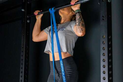 blue serious steel band assisting a woman with pull-up