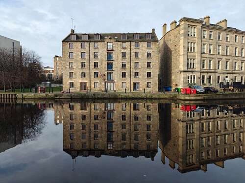 a photo of a building on a river