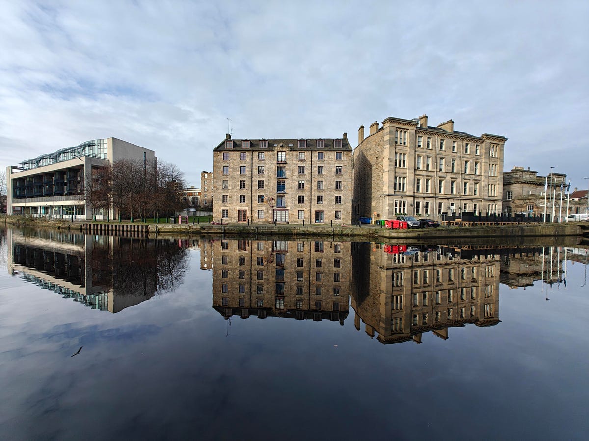 a photo of a building on a river