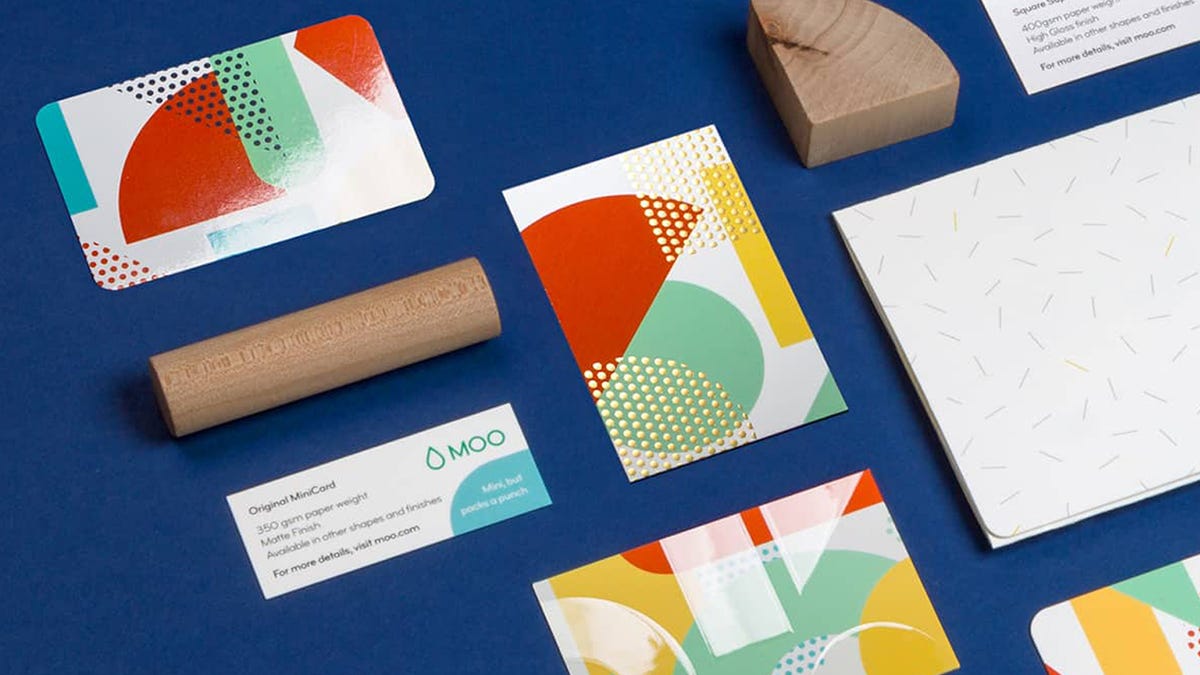 Colorful and creative business cards printed by Moo in various sizes and styles rest on a blue background.