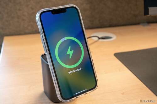 Charging an iPhone on the wireless charging pad on top of the UGreen 100W 2-in-1 GaN Charger.