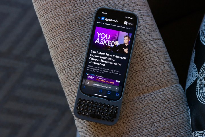 An iPhone in a dark navy Clicks keyboard case.