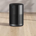 The Dreo Macro Pro Air Purifier sits on a wooden floor