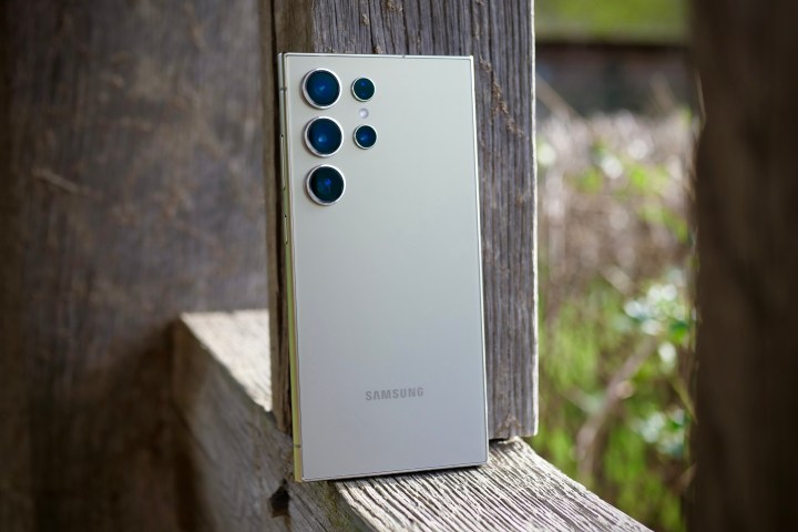 The back of the Samsung Galaxy S24 Ultra, resting against a post.