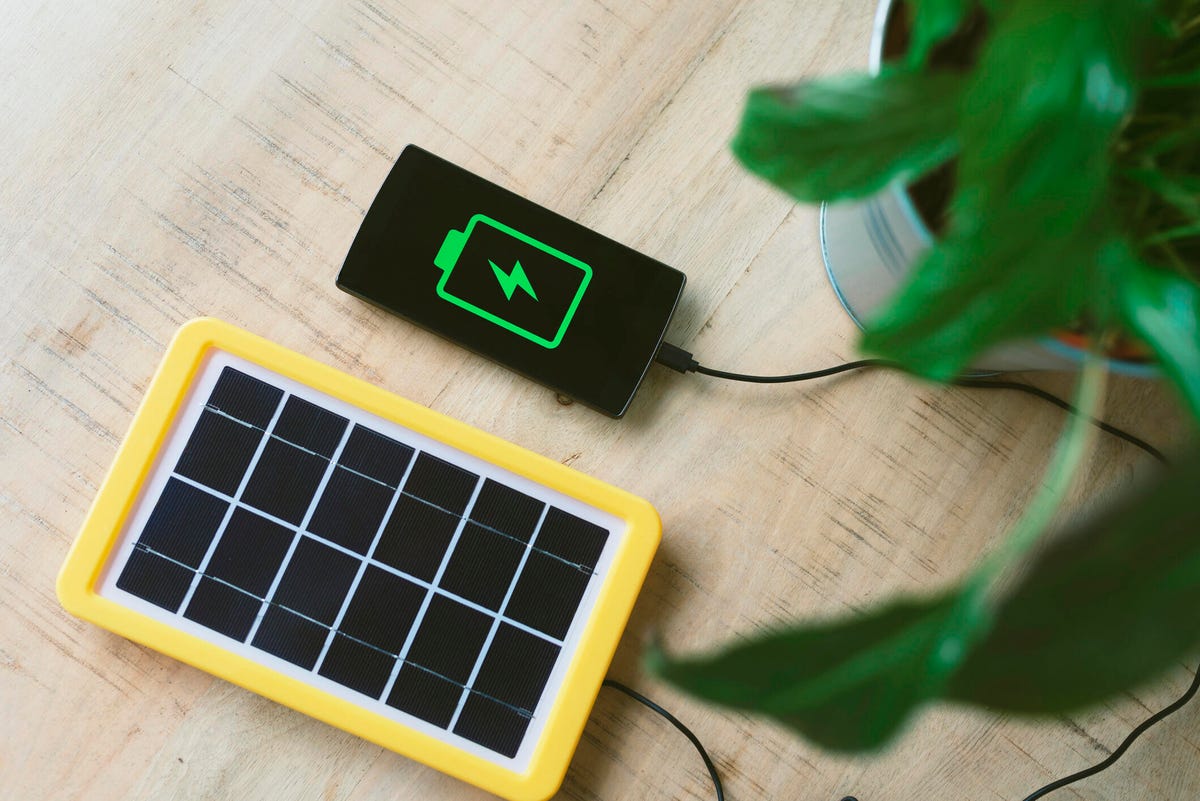 a small solar panel charging a smart phone