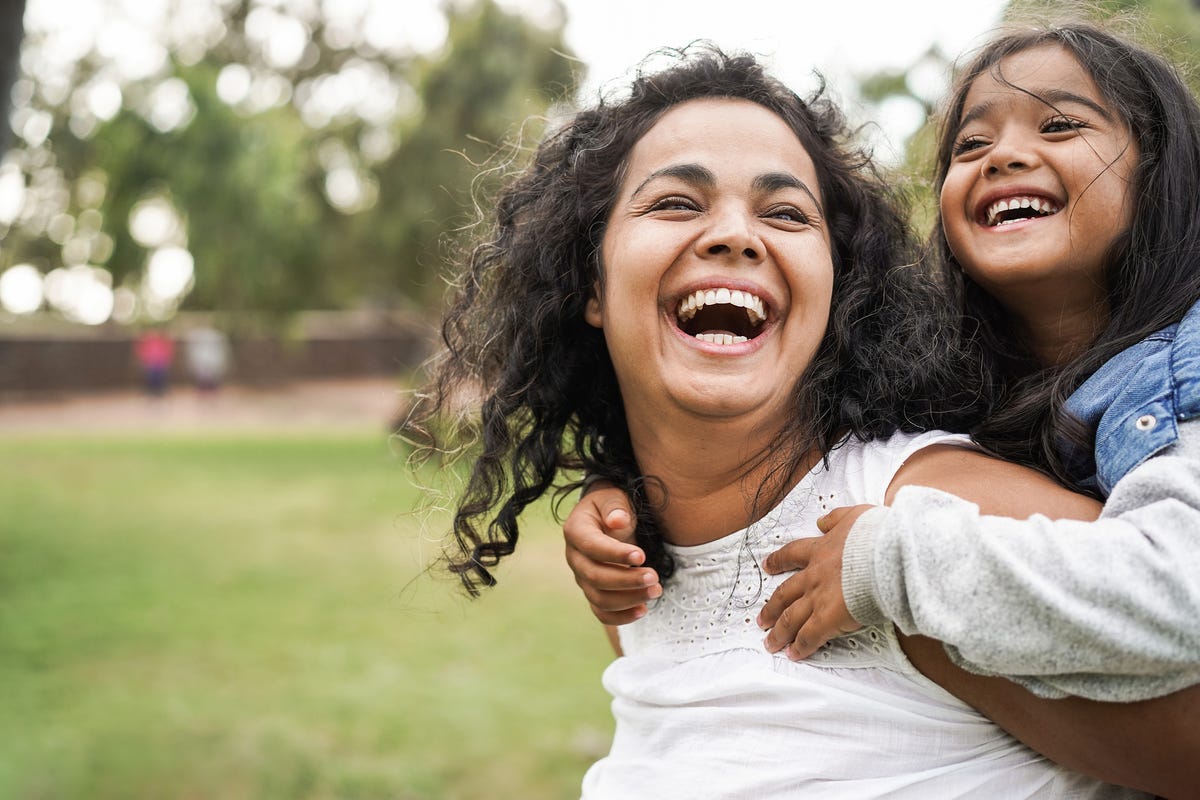 mother having fun with her daughter outdoors