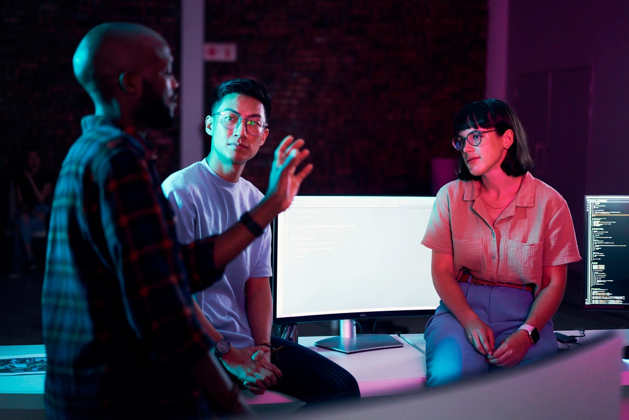 Three people talking in an office