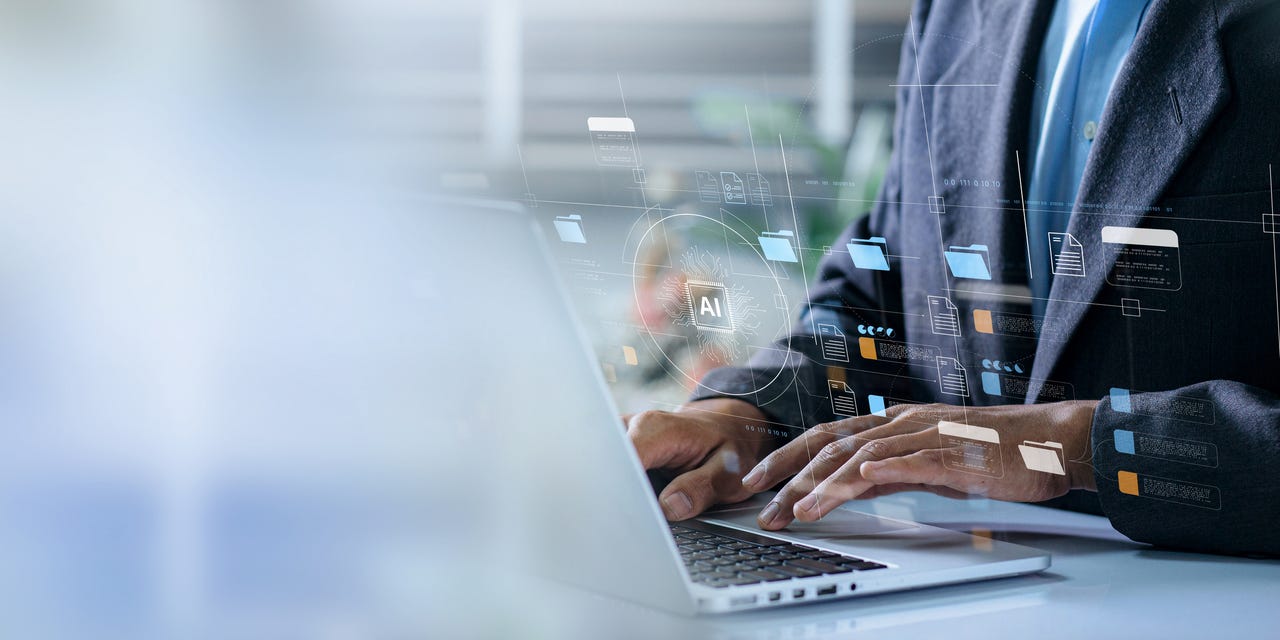 man at laptop working with AI tools