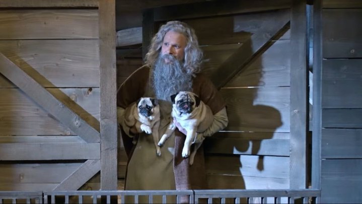 Noah looks out a door while holding dogs in a scene from "History of the World, Part II."