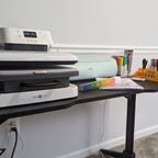 Large heatpress next to a green Cricut machine