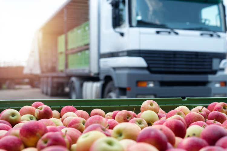 Fruit and food distribution. Truck loaded with containers full of apples ready to be shipped to the market.