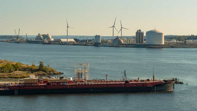 Big barge going along Providence River, view of industrial district.