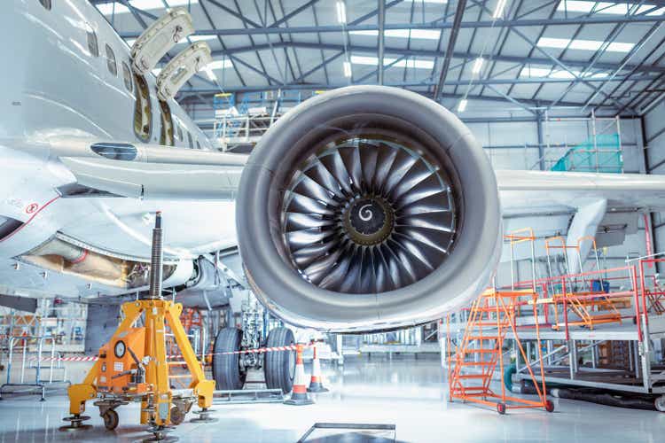 Large jet engine in aircraft maintenance hangar