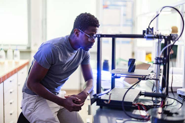 Male Engineer Looking At 3D Printer