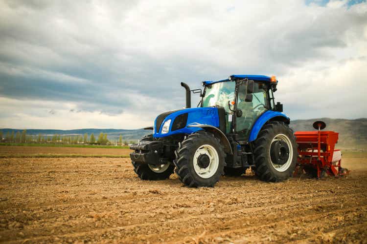 farmer planting seeds with tractor and seeder