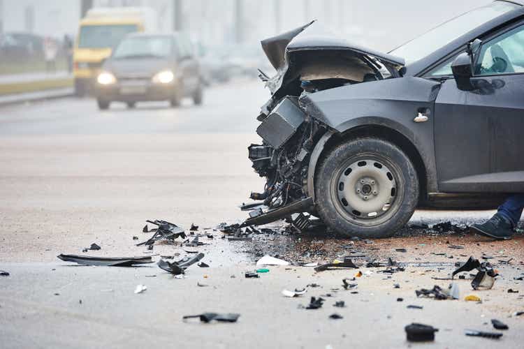 Car crash in urban street with black car