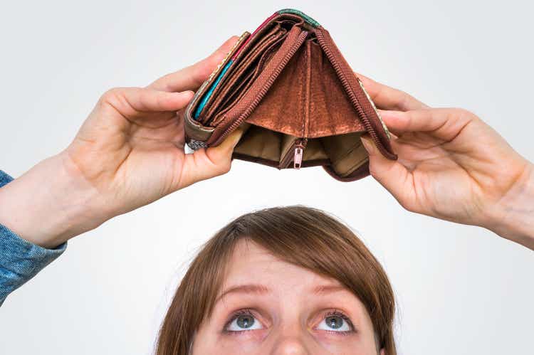 Woman holding an empty wallet, she hasn