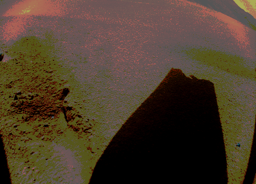 A broken Ingenuity rotor tip's shadow cast onto the Martian ground.