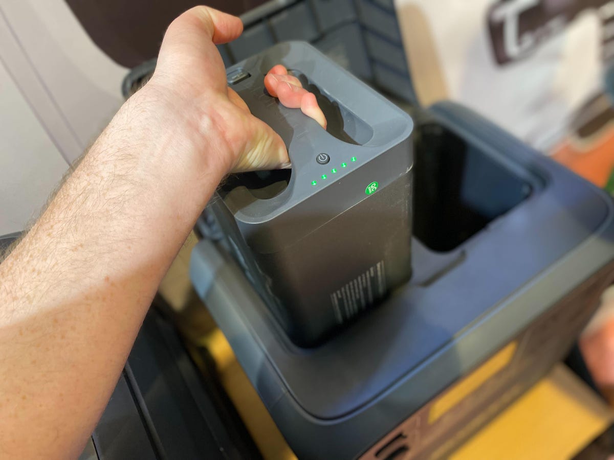 The author lifting a battery pack out of a power station.