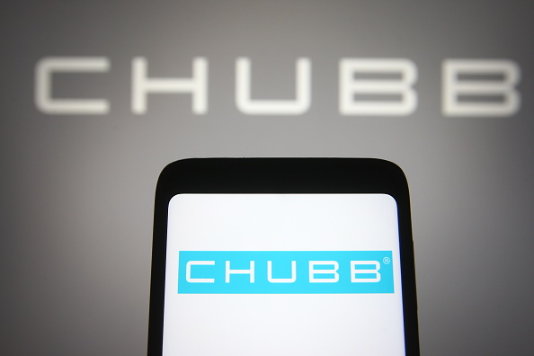 In this photo illustration a Chubb Limited logo of an...