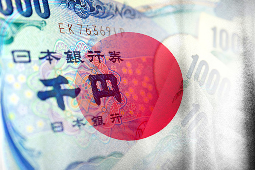 Japan flag and Japanese Yen cash bills