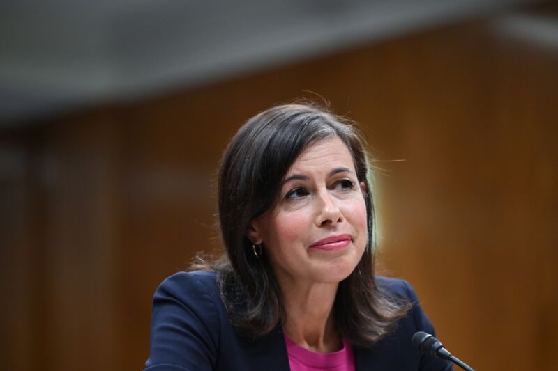 FCC Chairwoman Jessica Rosenworcel sits at a table in front of a microphone at a Senate subcommittee hearing.