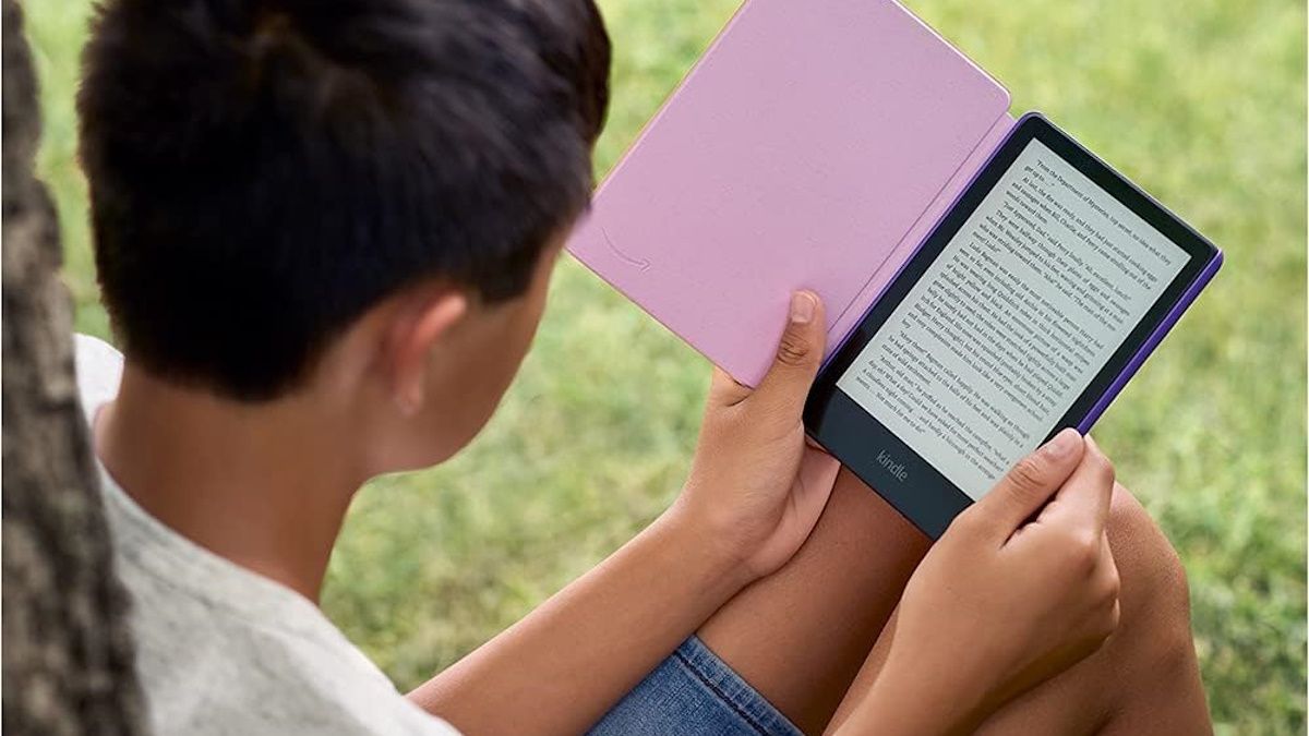 Child reading paperwhite kids outside