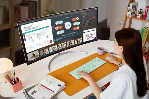 A Person working while videoconferencing on an LG 40WP95C-W monitor