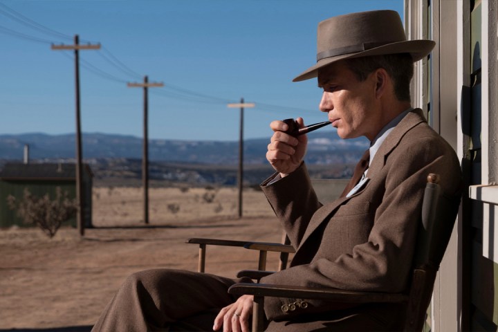 A man sits on a chair in Oppenheimer.