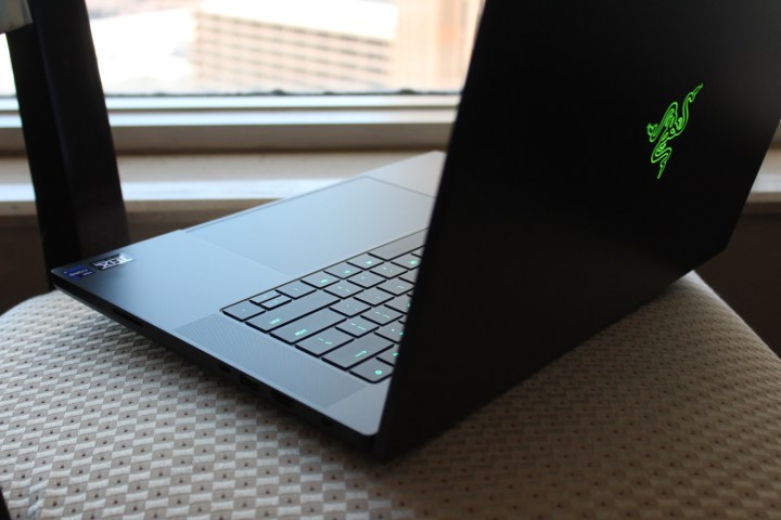 The Razer Blade 16 on a chair in front of a window.