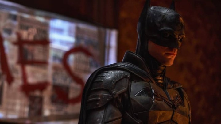 Batman stares down at a crime scene in The Batman.