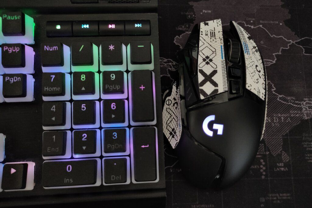 The Corsair K70 keyboard and Logitech G502 mouse with synced RGB effects.