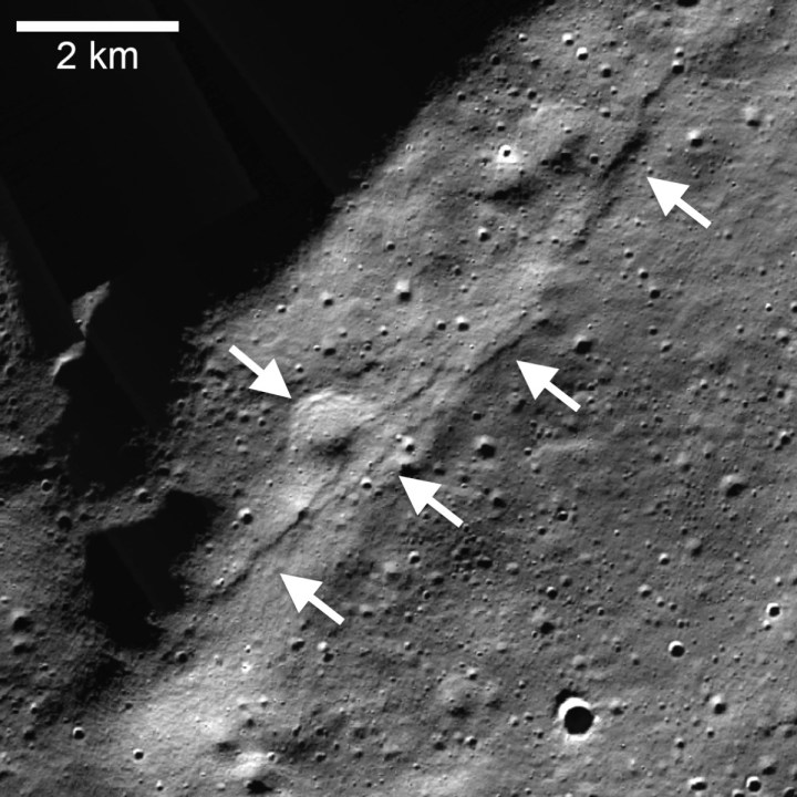 Lunar Reconnaissance Orbiter Camera (LROC), Narrow Angle Camera (NAC) mosaic of the Wiechert cluster of lobate scarps (left pointing arrows) near the lunar south pole. A thrust fault scarp cut across an approximately 1-kilometer (0.6-mile) diameter degraded crater (right pointing arrow). 