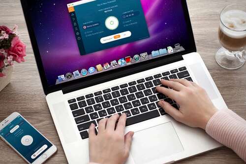 Person using a VPN on a laptop and smartphone.