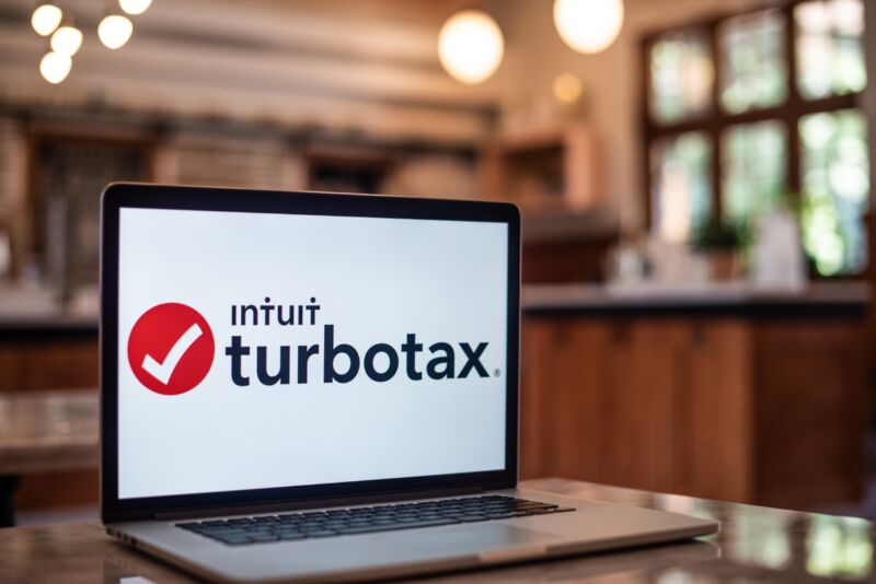 A laptop screen displays the logo for Intuit TurboTax.