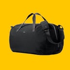 Black Venture duffle bag against a yellow background