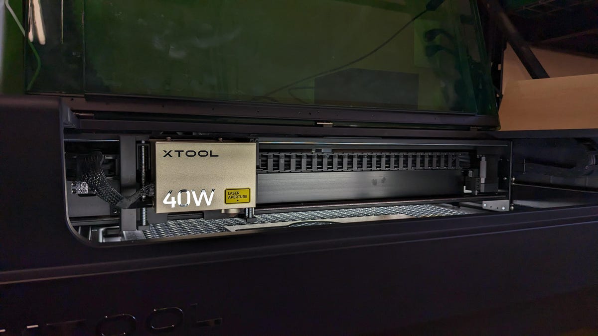 Xtool S1 laser module in the light with darkness around it